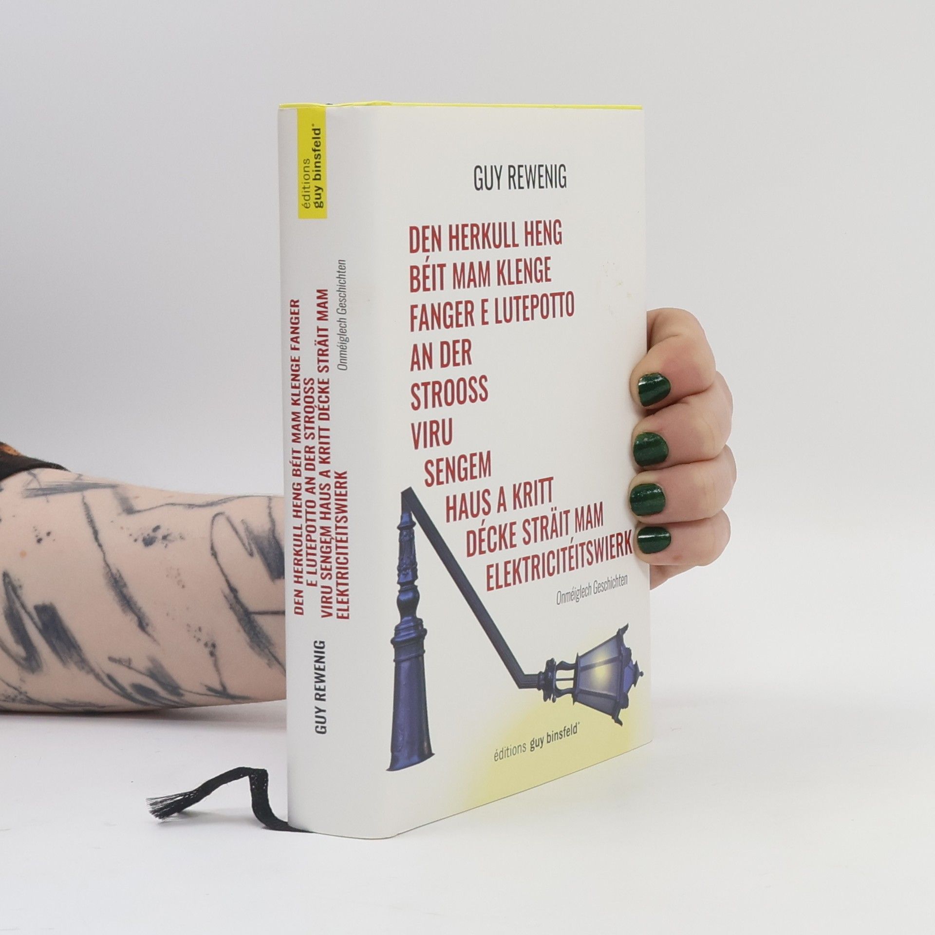 Guy Rewenig Den Herkull Heng béit mam klenge Fanger e Lutepotto an der Strooss viru sengem Haus a kritt décke Sträit mam Elektricitéitswierk